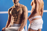 Two models in PUMP! Clay Thongs with white tennis shorts pulled down
