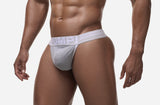 Three-quarter front view of the grey and white PUMP! Clay Thong