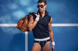 Model wearing the PUMP! Courtside Jockstrap under a navy polo with a leather holdall