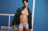 Model wearing the white PUMP! Deuce Boxer and a green jacket on a blue tennis court