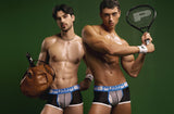 Two models in PUMP! Match Point boxers with a tennis racket and leather holdall